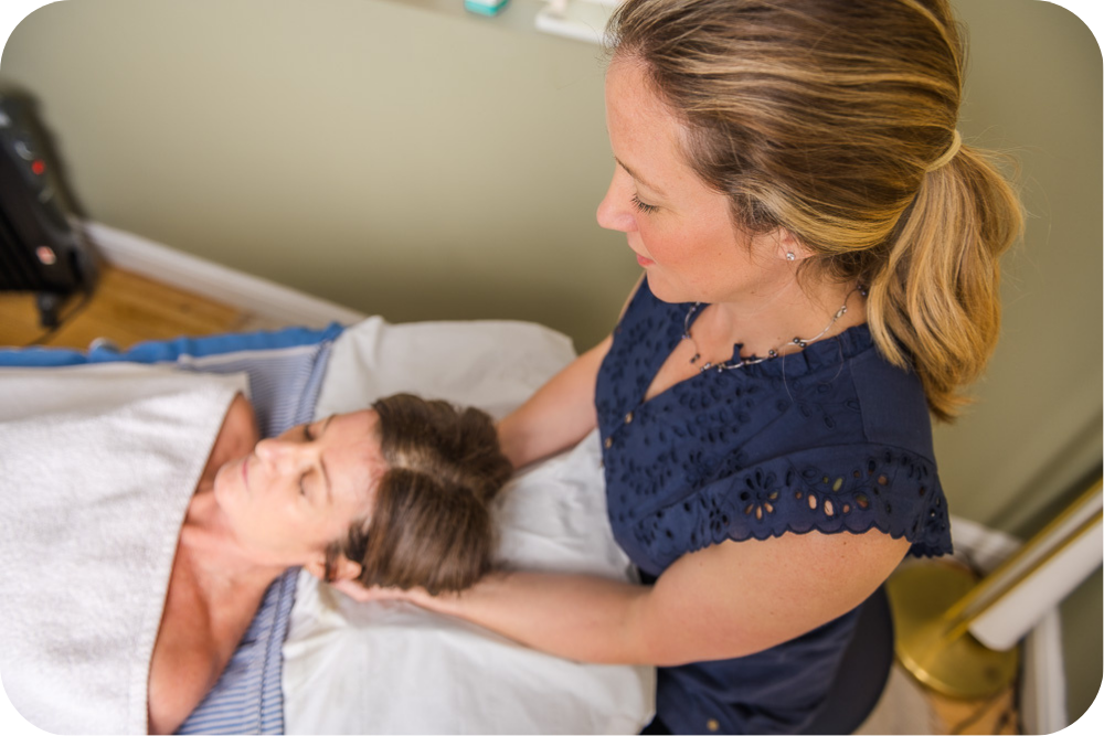 Katie providing craniosacral therapy to a patient